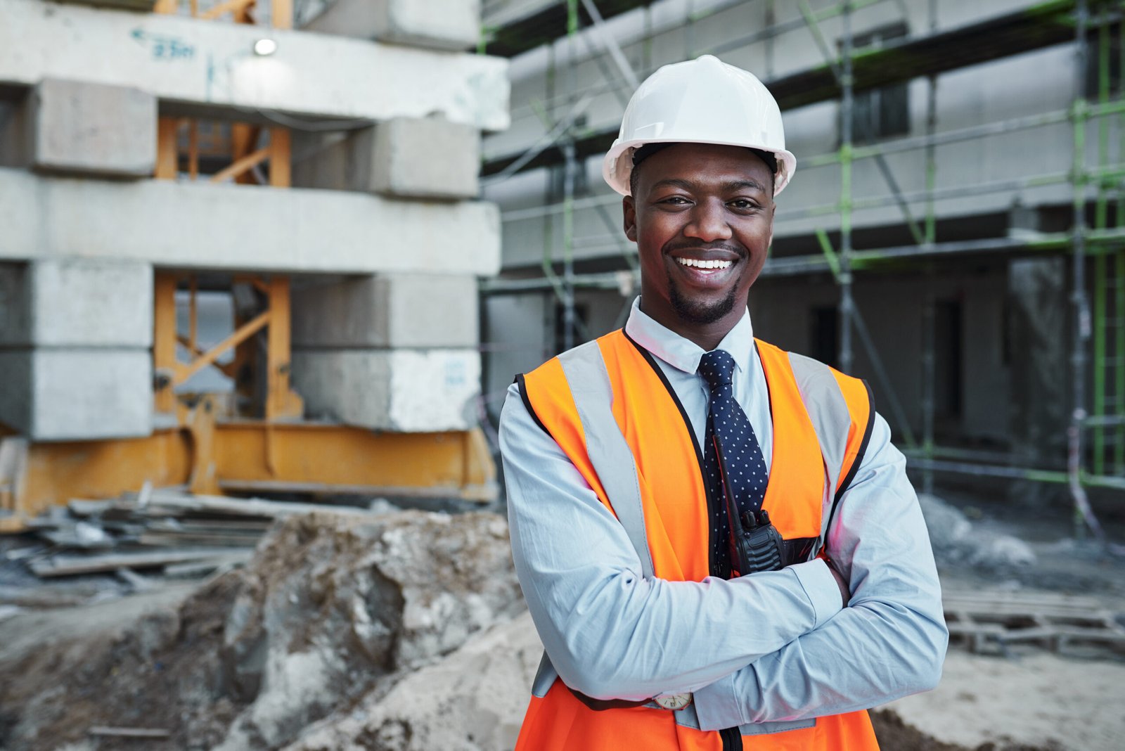 portrait of a confident young man working at a construction site.