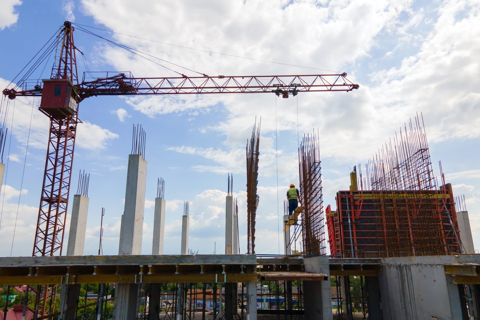 tower crane at high concrete residential building under construction. real estate development concept.